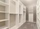 Spacious walk-in closet with custom shelving and ample storage space at 2701 N Black Rock Rd, Buckeye, AZ 85396