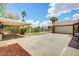 Spacious backyard featuring a covered patio, carport, and garage with a fenced lawn area at 2846 E Lupine Ave, Phoenix, AZ 85028