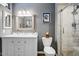 Well-lit bathroom featuring a vanity with dual sinks and a walk-in shower at 2846 E Lupine Ave, Phoenix, AZ 85028