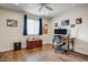 Bright bedroom with wood flooring, desk, ceiling fan, and an organized workspace at 2846 E Lupine Ave, Phoenix, AZ 85028