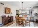 Charming dining area with a round wooden table and chairs, complemented by a modern light fixture at 2846 E Lupine Ave, Phoenix, AZ 85028