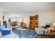 Open-concept living room with stylish furniture, including a sofa, ottoman, and a decorative hutch at 2846 E Lupine Ave, Phoenix, AZ 85028