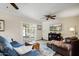 Comfortable living room featuring a ceiling fan, sliding glass doors, and wood flooring at 2846 E Lupine Ave, Phoenix, AZ 85028