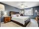 Comfortable bedroom with a ceiling fan, nightstands and soft carpet at 2846 E Lupine Ave, Phoenix, AZ 85028
