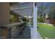 Covered outdoor bar and kitchen area with stools and patio at 2886 E Hazeltine Way, Chandler, AZ 85249