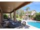 Inviting backyard with a covered patio, pool, outdoor kitchen, and manicured landscaping, perfect for entertaining at 2886 E Hazeltine Way, Chandler, AZ 85249