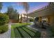 Manicured backyard with BBQ, fire pit, turf, and pergola at 2886 E Hazeltine Way, Chandler, AZ 85249
