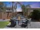 Fire pit with stone surround and seating, surrounded by landscaping at 2886 E Hazeltine Way, Chandler, AZ 85249