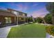 Large backyard with turf, patio, and outdoor kitchen under a pergola at 2886 E Hazeltine Way, Chandler, AZ 85249