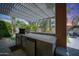 Backyard kitchen with built-in grill and concrete patio under pergola at 2886 E Hazeltine Way, Chandler, AZ 85249