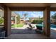 Inviting backyard featuring a covered patio, outdoor seating, sparkling pool, and well-manicured landscaping at 2886 E Hazeltine Way, Chandler, AZ 85249