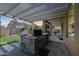 Backyard with grill, covered patio, and artificial turf at 2886 E Hazeltine Way, Chandler, AZ 85249