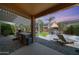 Outdoor kitchen, grill, lounge chairs, and fire pit on a brick patio at 2886 E Hazeltine Way, Chandler, AZ 85249