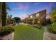 Wide backyard with pool, patio, outdoor kitchen, and artificial turf at 2886 E Hazeltine Way, Chandler, AZ 85249