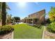 Sprawling backyard with lush artificial turf, pool, patio, outdoor kitchen and manicured landscaping at 2886 E Hazeltine Way, Chandler, AZ 85249