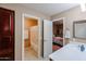 Neutral bathroom featuring a combination shower and tub alongside a modern vanity and views of the bedroom at 2886 E Hazeltine Way, Chandler, AZ 85249