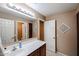 Bathroom with a sink vanity and tiled floors with bright lighting and mirrors at 2886 E Hazeltine Way, Chandler, AZ 85249