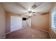 Cozy bedroom with carpet, a ceiling fan, and closet space for optimal storage and a clean design at 2886 E Hazeltine Way, Chandler, AZ 85249