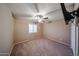 Neutral-toned bedroom featuring carpeting, a ceiling fan, and bright, natural light at 2886 E Hazeltine Way, Chandler, AZ 85249