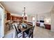 Dining area with a view to kitchen, and study room, offering a seamless transition for modern living and entertaining at 2886 E Hazeltine Way, Chandler, AZ 85249