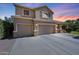 Attractive two-story home with a three-car garage, manicured lawn, and inviting front porch at 2886 E Hazeltine Way, Chandler, AZ 85249