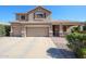 Inviting two-story home with a three-car garage, covered front porch, and landscaped yard at 2886 E Hazeltine Way, Chandler, AZ 85249