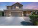 Charming two-story home showcasing a three-car garage and well-maintained landscaping, enhancing curb appeal at 2886 E Hazeltine Way, Chandler, AZ 85249