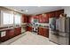 A full kitchen showcases stainless appliances and plenty of cabinet space with a big window above the sink at 2886 E Hazeltine Way, Chandler, AZ 85249