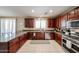 A full kitchen showcases stainless appliances and plenty of cabinet space with a big island and window above the sink at 2886 E Hazeltine Way, Chandler, AZ 85249