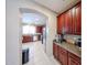 Well-equipped kitchen with stainless steel appliances, rich cabinetry, and tile flooring at 2886 E Hazeltine Way, Chandler, AZ 85249