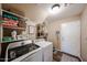 Functional laundry room equipped with washer, dryer, and ample storage shelves at 2886 E Hazeltine Way, Chandler, AZ 85249