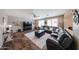 Spacious living room with hardwood floors, a large sectional sofa, and a modern entertainment center, perfect for relaxation at 2886 E Hazeltine Way, Chandler, AZ 85249