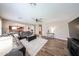 Open concept living room with wood floors, a ceiling fan, and comfortable seating at 2886 E Hazeltine Way, Chandler, AZ 85249