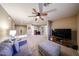 Spacious living room with plush carpeting, ceiling fan, and comfortable seating area for relaxation and entertainment at 2886 E Hazeltine Way, Chandler, AZ 85249