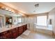 Spacious bathroom with dual sinks, large mirror, walk-in shower, and luxurious soaking tub at 2886 E Hazeltine Way, Chandler, AZ 85249