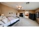 Large main bedroom with plush carpeting, ceiling fan, and a full view into the ensuite bathroom at 2886 E Hazeltine Way, Chandler, AZ 85249