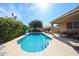 Sparkling pool with baja step, surrounding patio, seating area and lush landscaping at 2886 E Hazeltine Way, Chandler, AZ 85249