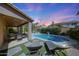 Backyard showcasing a sparkling pool, covered patio, lounge chairs, and lush landscaping, creating a serene retreat at 2886 E Hazeltine Way, Chandler, AZ 85249