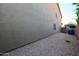 Practical side yard featuring gravel landscaping, access gate, and exterior wall with minimal windows at 2886 E Hazeltine Way, Chandler, AZ 85249