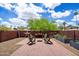 Inviting backyard patio area featuring brickwork, comfortable seating, and a cozy fire pit at 2941 E Nisbet Ct, Phoenix, AZ 85032