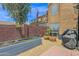Backyard brick patio with garden planters and mature trees, great for outdoor activities at 2941 E Nisbet Ct, Phoenix, AZ 85032