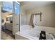 Lovely bathroom featuring a soaking tub with an access window and decor at 2941 E Nisbet Ct, Phoenix, AZ 85032