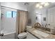 Modern bathroom with granite countertops and tub/shower combination at 2941 E Nisbet Ct, Phoenix, AZ 85032