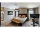 Comfortable main bedroom featuring a ceiling fan, a bench, and plenty of natural light at 2941 E Nisbet Ct, Phoenix, AZ 85032