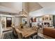 Dining area features a rustic table, elegant chandelier, and stylish decor at 2941 E Nisbet Ct, Phoenix, AZ 85032
