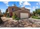 Charming home featuring a two-car garage, desert landscaping, and a welcoming facade at 2941 E Nisbet Ct, Phoenix, AZ 85032