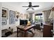 Inviting home office featuring ample desk space, natural light, and eclectic wall decor at 2941 E Nisbet Ct, Phoenix, AZ 85032