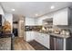 Well-lit kitchen includes granite countertops, white cabinets, and stainless steel appliances at 2941 E Nisbet Ct, Phoenix, AZ 85032