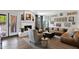 Inviting living room featuring a brick fireplace, leather couch and natural light at 2941 E Nisbet Ct, Phoenix, AZ 85032
