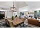 Open-concept living space showcasing a dining area that transitions into a cozy living area with a fireplace at 2941 E Nisbet Ct, Phoenix, AZ 85032